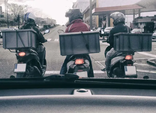 Repartidores en moto.